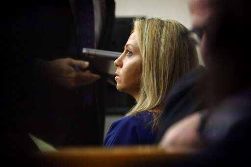 Fired Dallas Police Officer Amber Guyger listens as her attorneys make arguments during her murder trial, Monday, Sept. 23, 2019, in Dallas. Guyger went on trial in the shooting death of a black neighbor as attorneys sparred over whether the officer was distracted by a phone call when she mistook the neighbors apartment for her own and the victim for an intruder. (Tom Fox/The Dallas Morning News via AP, Pool)