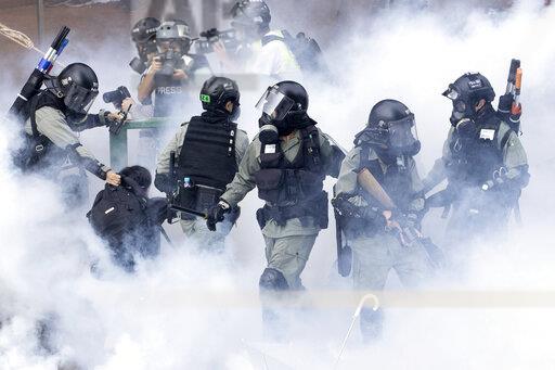 Police launch tear gas at protesters in Hong Kong, 
Courtesy of the Associated Press