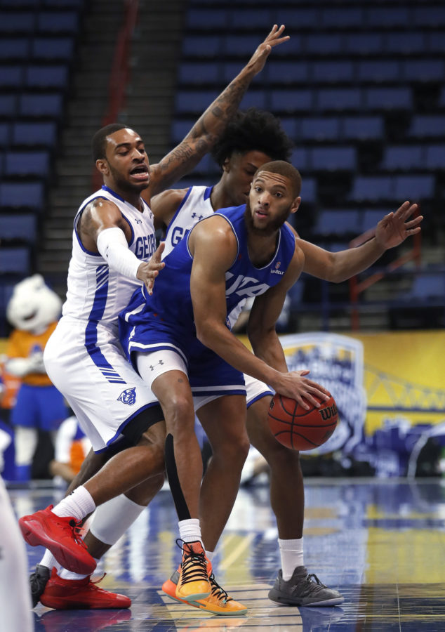 Texas-Arlington guard Edric Dennis (5) is defended by Georgia State guards Damon Wilson and Kane Williams during the first half of an NCAA college basketball game for the Sun Belt Conference mens tournament championship in New Orleans, Sunday, March 17, 2019. Georgia State won 73-64. (AP Photo/Tyler Kaufman)