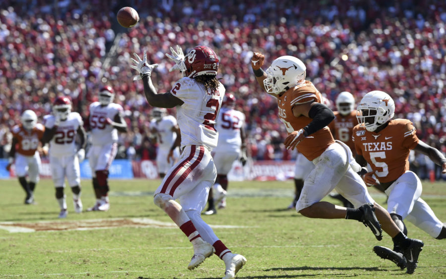 Oklahoma wide receiver CeeDee Lamb (2) hauls in his third touchdown reception in front of Texas defensive back Brandon Jones (19) in the second half of an NCAA college football game at the Cotton Bowl, Saturday, Oct. 12, 2019, in Dallas. Lamb finished with 171 receiving yards and three touchdowns as Oklahoma won 34-27. (AP Photo/Jeffrey McWhorter)