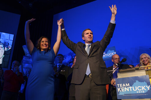 Democratic gubernatorial candidate and Kentucky Attorney General Andy Beshear, along with lieutenant governor candidate Jacqueline Coleman, acknowledge supporters at the Kentucky Democratic Party election night watch event, Tuesday, Nov. 5, 2019, in Louisville, Ky. (AP Photo/Bryan Woolston)