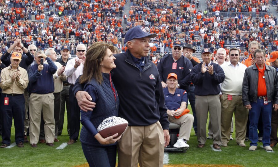 FILE - In this Saturday, Nov. 19, 2011, file photo, Samford coach Pat Sullivan is recognized with wife Jean on the 40th anniversary of his winning the Heisman trophy as quarterback at Auburn, before an NCAA college football game between Samford and Auburn, in Auburn, Ala. Sullivan, the 1971 Heisman Trophy winner at Auburn who went on to coach TCU and Samford, died Sunday, Dec. 1, 2019. He was 69. (AP Photo/Butch Dill, File)