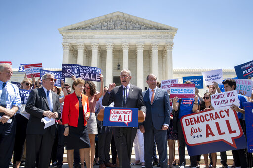 Democratic senators, from left, Sen. Chris Van Hollen, D-Md., Sen. Dick Durbin, D-Ill., Sen. Jeanne Shaheen, D-N.H., Senate Minority Leader Chuck Schumer, D-N.Y., and Sen. Tom Udall, D-N.M., announce the introduction of a constitutional amendment that would overturn Citizens United v. FEC decision to get big money out of politics, at the Supreme Court in Washington, Tuesday, July 30, 2019. (AP Photo/J. Scott Applewhite)