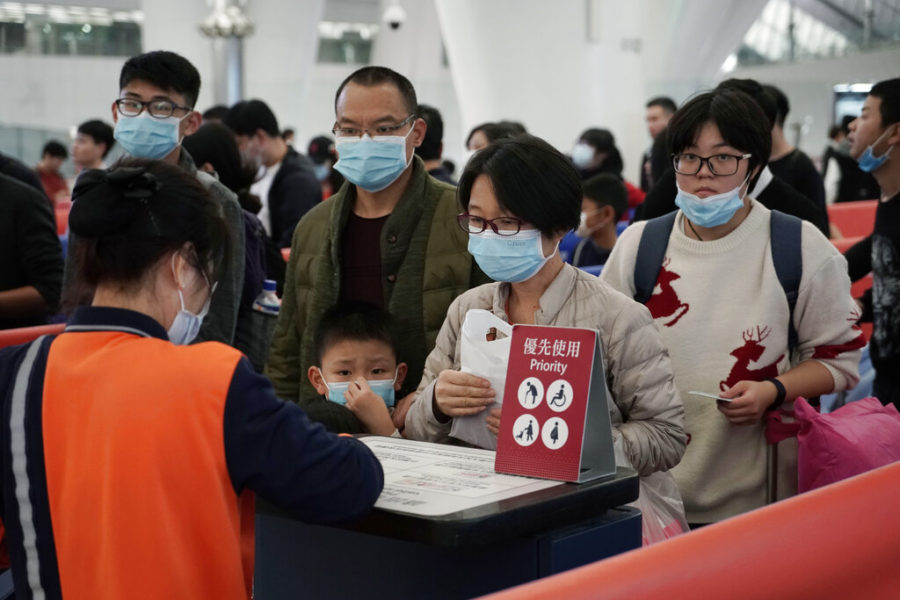 Passengers wear masks to prevent an outbreak of a new coronavirus in the high speed train station, in Hong Kong, Wednesday, Jan. 22, 2020. The first case of coronavirus in Macao was confirmed on Wednesday, according to state broadcaster CCTV. The infected person, a 52-year-old woman, was a traveller from Wuhan. (AP Photo/Kin Cheung)