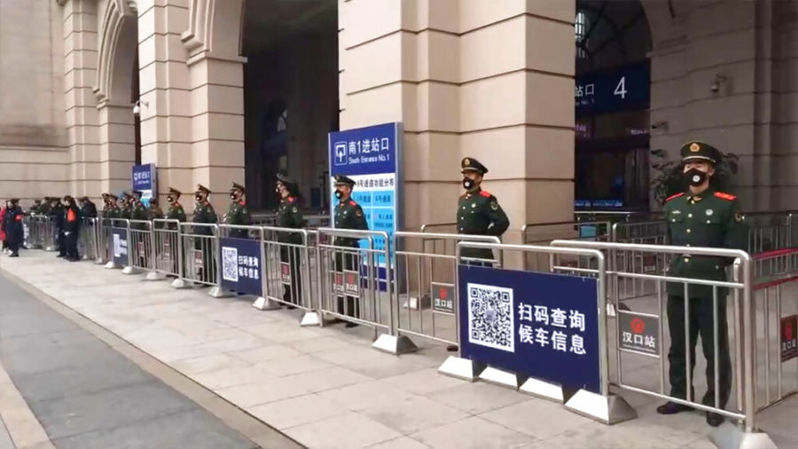 In this image made from video, Chinese paramilitary police stand guard outside the closed Hankou Railway Station in Wuhan in central Chinas Hubei Province, Thursday, Jan. 23, 2020. China closed off a city of more than 11 million people Thursday in an unprecedented effort to try to contain a deadly new viral illness that has sickened hundreds and spread to other cities and countries in the Lunar New Year travel rush. (The Paper via AP)