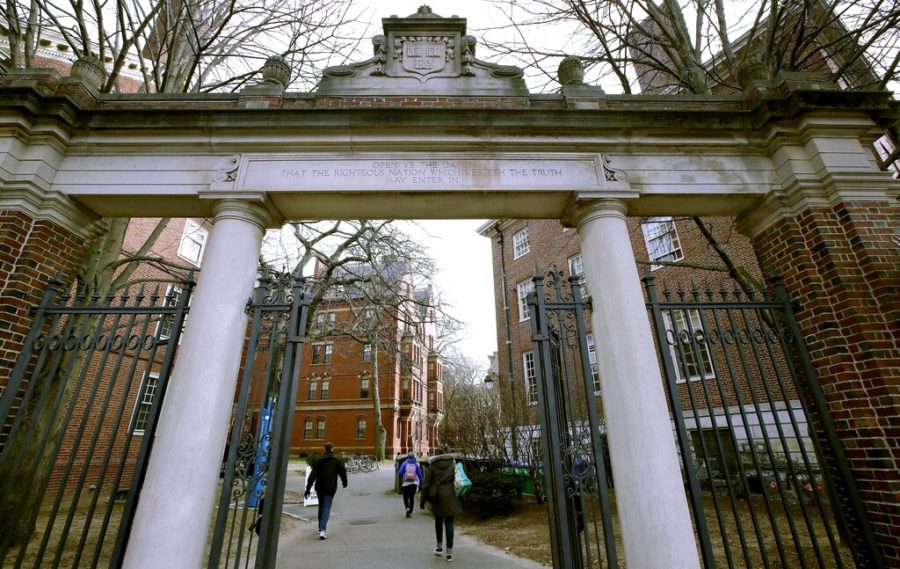 FILE - In this Dec. 13, 2018, file photo, a gate opens to the Harvard University campus in Cambridge, Mass. The U.S. Education Department said Wednesday, Feb. 12, 2020, it is investigating foreign gifts made to Harvard and Yale as part of a broader review of international money flowing to American universities. (AP Photo/Charles Krupa, File)