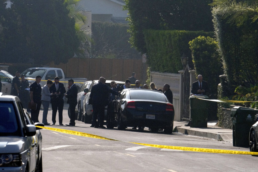 Police officers and investigators work outside a Hollywood Hills home where a fatal shooting occurred on Wednesday, Feb. 19, 2020, in Los Angeles. (AP Photo/Ringo H.W. Chiu)