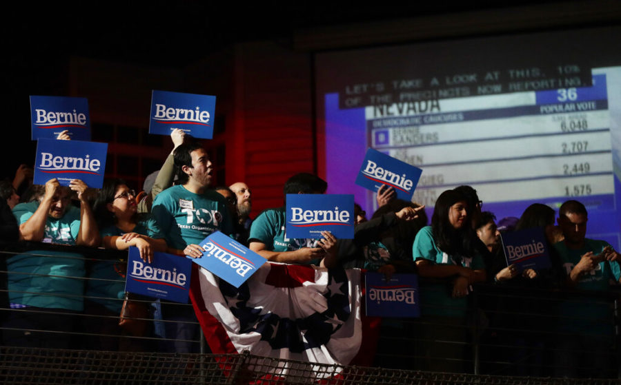 Supporters of Democratic presidential candidate Sen. Bernie Sanders, I-Vt., cheer as they watch results of the Nevada Cacus during a campaign event in San Antonio, Saturday, Feb. 22, 2020. (AP Photo/Eric Gay)