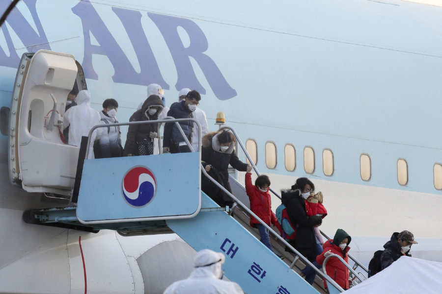 FILE - In this Friday, Jan. 31, 2020, file photo, South Koreans evacuated from Wuhan, China, disembark from a chartered flight at Gimpo Airport in Seoul, South Korea. A scary new virus from China has spread around the world. So has rising anti-Chinese sentiment, calls for a full travel ban on Chinese visitors and indignities for Chinese and other Asians. South Korean websites have been flooded with comments calling on the government to block or expel Chinese and racist remarks about Chinese eating habits and hygiene. (Kim Kyun-hyun/Newsis via AP, File)