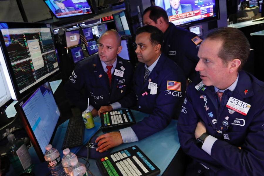 Specialists Mario Picone, Dilip Patel and Glenn Carrel, left to right, work on the floor of the New York Stock Exchange, Tuesday, Feb. 25, 2020. U.S. stocks fell in midday trading Tuesday, a day after the markets biggest drop in two years, as traders worry that the spreading coronavirus will threaten global economic growth. (AP Photo/Richard Drew)