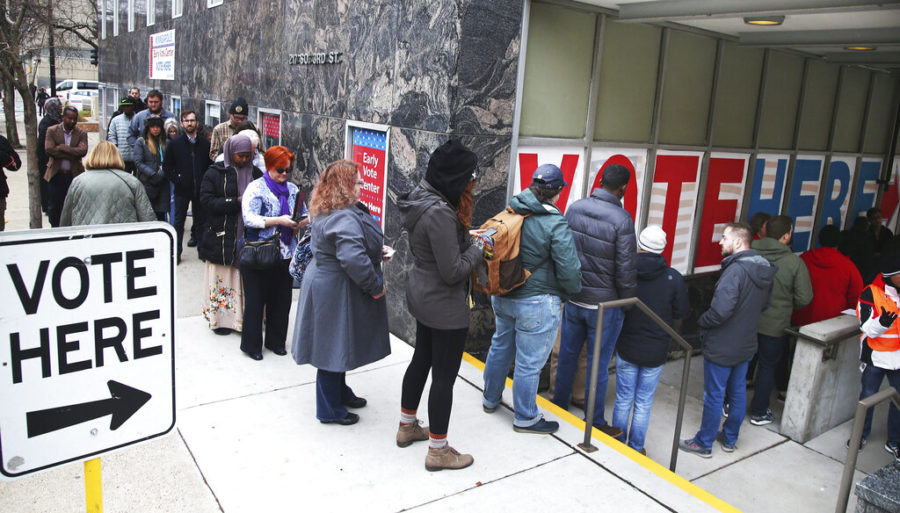 FILE - In this Nov. 5, 2018 file photo, people line up to vote on the last day of early voting at the Minneapolis Early Vote Center in Minneapolis. Democratic Secretary of State Steve Simon and a bipartisan group of lawmakers want to move quickly on a bill to protect the privacy of Minnesotans who vote in the 2020 Super Tuesday presidential primary March 3, 2020 (AP Photo/Jim Mone)