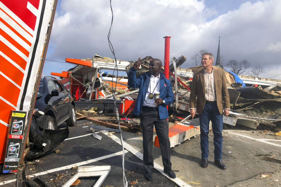 Tennessee Gov. Bill Lee, right and Tennessee Commerce and Insurance Commissioner Hodgen Mainda survey storm damage, in Nashville, Tenn. on Tuesday, March 3, 2020. Tornadoes ripped across Tennessee early Tuesday, shredding at least 40 buildings and killing many people. One of the twisters caused severe damage across downtown Nashville and leaving hundreds of people homeless. (AP Photo/Travis Loller)