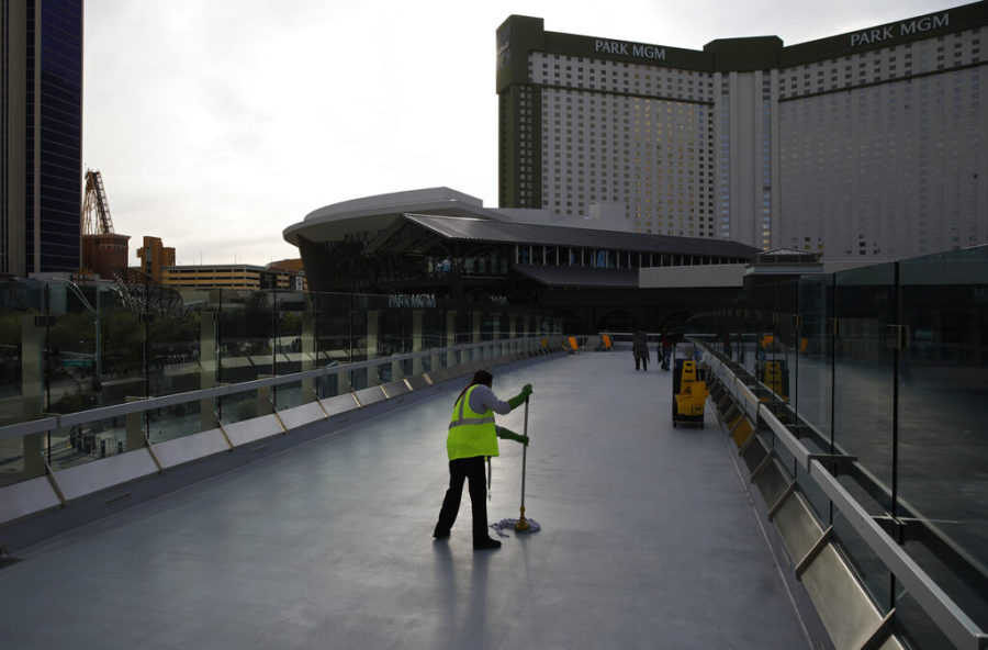A worker cleans along the Las Vegas Strip devoid of the usual crowds as casinos and other business are shuttered due to the coronavirus outbreak, Tuesday, March 31, 2020, in Las Vegas. (AP Photo/John Locher)