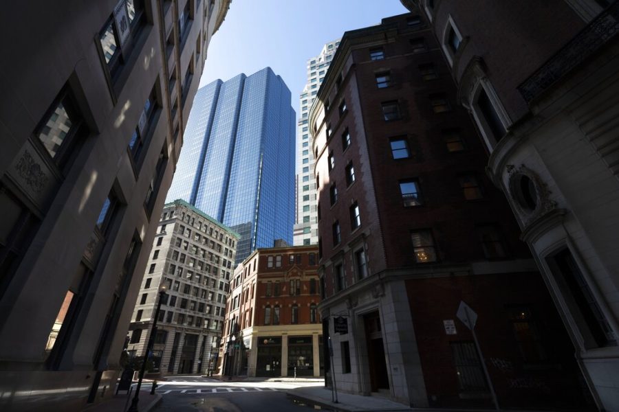 Buildings line the empty streets in downtown Boston, Saturday, April 4, 2020,. The new coronavirus causes mild or moderate symptoms for most people, but for some, especially older adults and people with existing health problems, it can cause more severe illness or death. (AP Photo/Michael Dwyer)