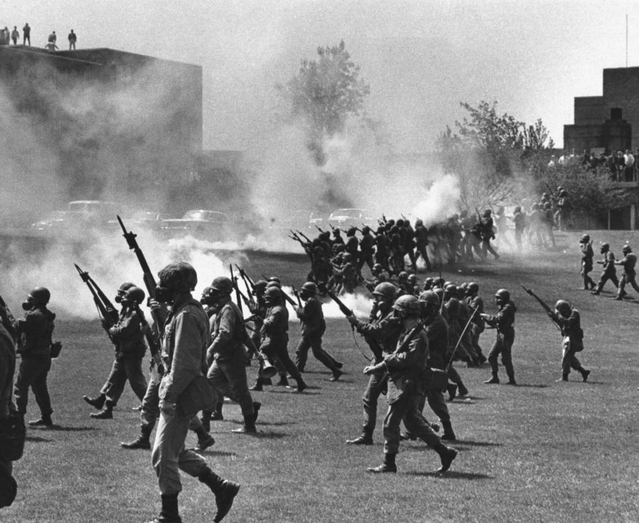 FILE - In a May 4, 1970 file photo, Ohio National Guard moves in on rioting students at Kent State University in Kent, Ohio. Four persons were killed and eleven wounded when National Guardsmen opened fire. The U.S. Justice Department, citing insurmountable legal and evidentiary barriers, wont reopen its investigation into the deadly 1970 shootings by Ohio National Guardsmen during a Vietnam War protest at Kent State University. Assistant Attorney General Thomas Perez discussed the obstacles in a letter to Alan Canfora, a wounded student who requested that the investigation be reopened. The Justice Department said Tuesday, April 24, 2012 it would not comment beyond the letter.  (AP Photo, File)