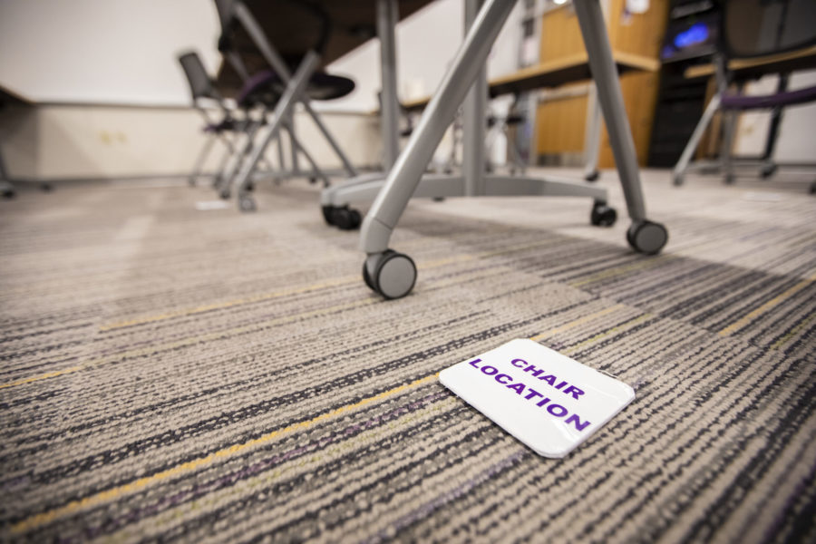 Chairs in a classroom are placed with social distancing in mind.