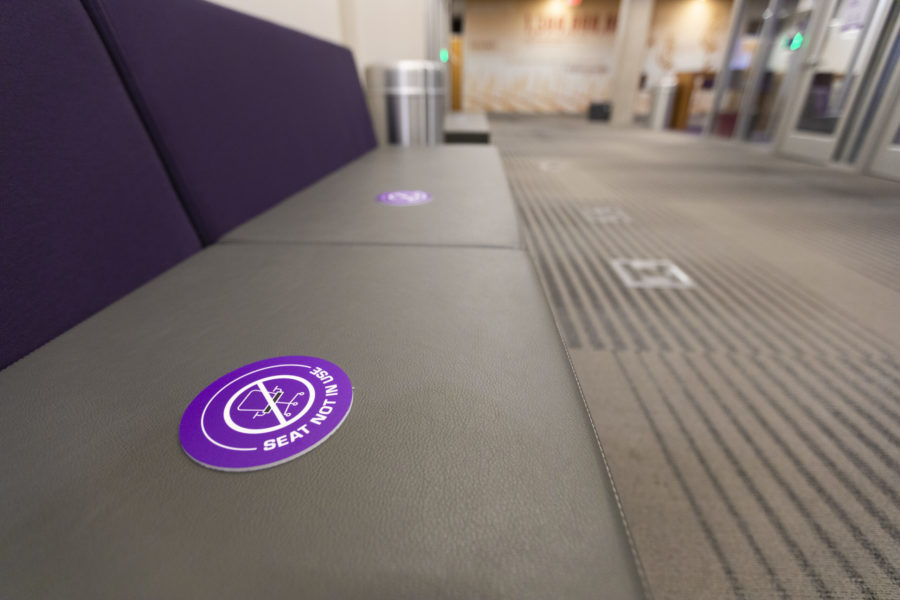 Seats in the library/Rees-Jones Hall are marked off as not in use.