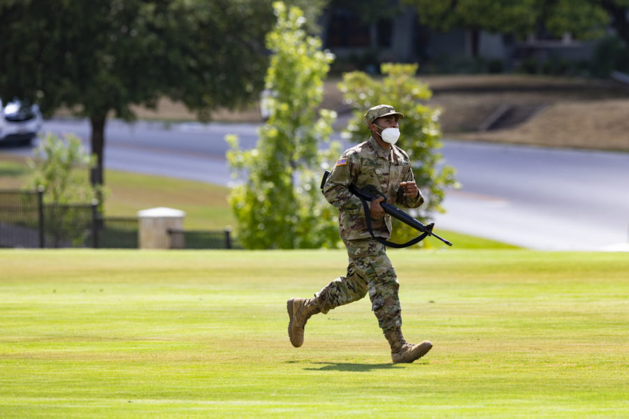 An ROTC cadet is training with a dummy M4 rifle.