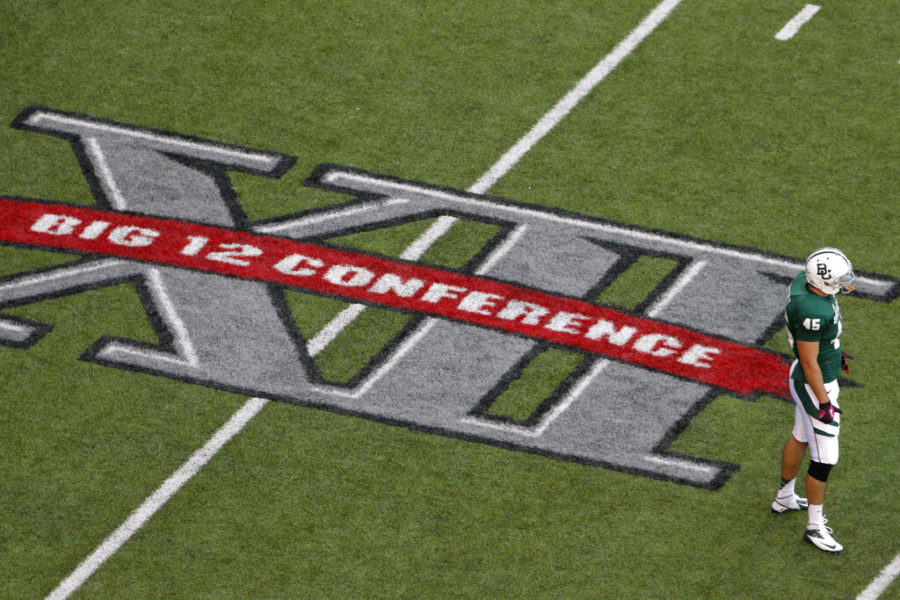 In this Oct. 13, 2012, file photo, Baylors Matt Ritchey (45) stands on the field by a Big 12 Conference logo during an NCAA college football game against TCU in Waco, Texas. Big 12 commissioner Bob Bowlsby feels good about where the league is with nine teams getting ready to play season openers this week. But the game not being played provides a stark reminder of the uncertainty of playing amid COVID-19. TCU wont be on the field because of a virus outbreak on its campus. (AP Photo/Tony Gutierrez)
