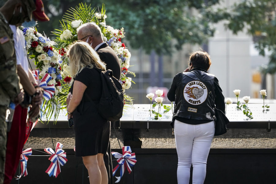 Mourners at the National September 11 Memorial and Museum hold a moment of silence to honor the victims of 9/11. (John Minchillo/AP Photo)
