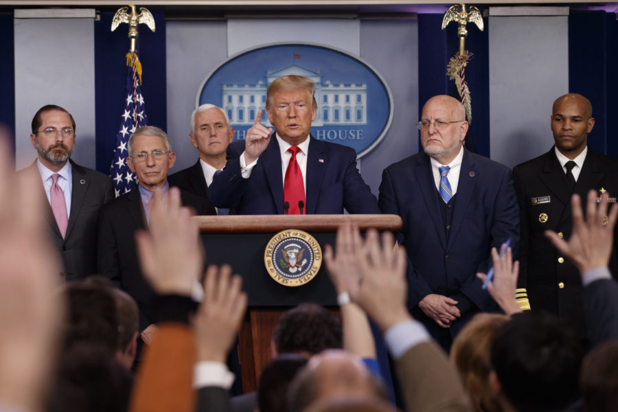 In this Feb. 29, 2020, file photo President Donald Trump, center, points as he prepares to answer question after speaking about the coronavirus in the press briefing room at the White House in Washington, as Health and Human Services Secretary Alex Azar, National Institute for Allergy and Infectious Diseases Director Dr. Anthony Fauci, Vice President Mike Pence, Robert Redfield, director of the Centers for Disease Control and Prevention and U.S. Surgeon General Dr. Jerome Adams listen. (AP Photo/Carolyn Kaster)