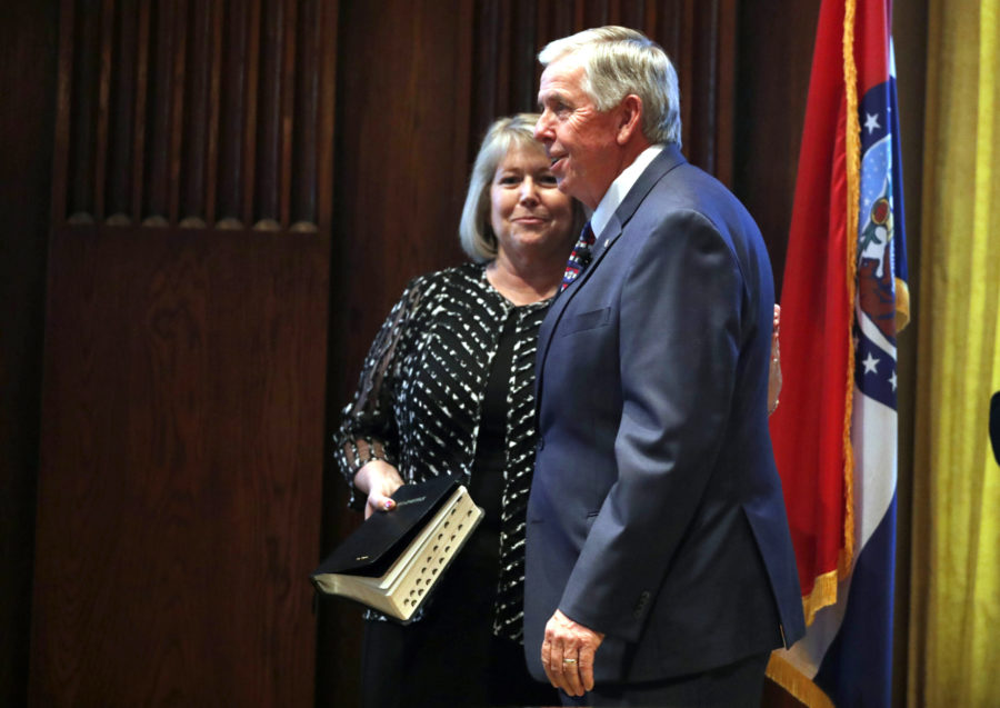 FILE - In this June 1, 2018 file photo, Gov. Mike Parson, right, smiles along side his wife, Teresa, after being sworn in as Missouris 57th governor in Jefferson City, Mo. Teresa Parson has tested positive for the coronavirus after experiencing mild symptoms, a spokeswoman for the governor said Wednesday, Sept. 23, 2020.  (AP Photo/Jeff Roberson, File)