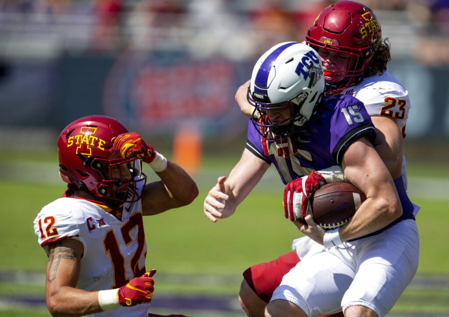Iowa State linebacker Mike Rose (23) and defensive back Greg Eisworth II (12) tackle TCU quarterback Max Duggan (15) during an NCAA college football game on Saturday, Sept. 26, 2020 in Fort Worth, Texas.