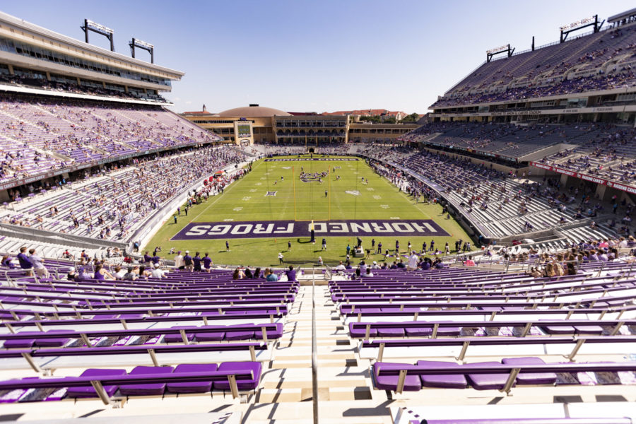 TCU fans sit socially distant in the stands during a football game.