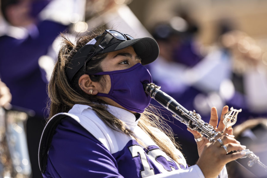 A+TCU+Band+member+plays+the+clarinet+through+her+mask+during+a+TCU+Football+game.