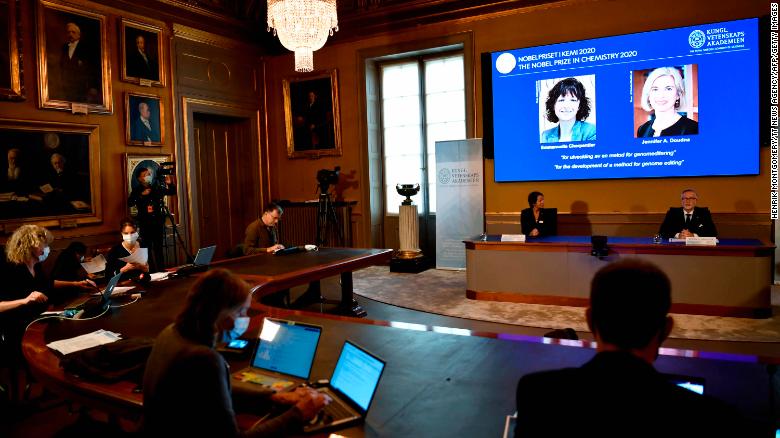 Professor Pernilla Wittung Stafshede (L) and Goran K. Hansson, Secretary General of the Academy of Sciences announce the winners of the 2020 Nobel prize in Chemistry shown on the screen French researcher in Microbiology, Genetics and Biochemistry Emmanuelle Charpentier (L) and US professor of Chemistry and of Molecular and Cell Biology, Jennifer Doudna at the Royal Swedish Academy of Sciences, in Stockholm, on October 7, 2020. (Photo by Henrik MONTGOMERY / various sources / AFP) / Sweden OUT (Photo by HENRIK MONTGOMERY/TT News Agency/AFP via Getty Images)