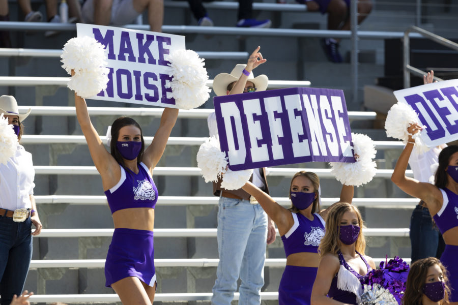 Cheerleaders cheer from the stands in the Kansas State football game.