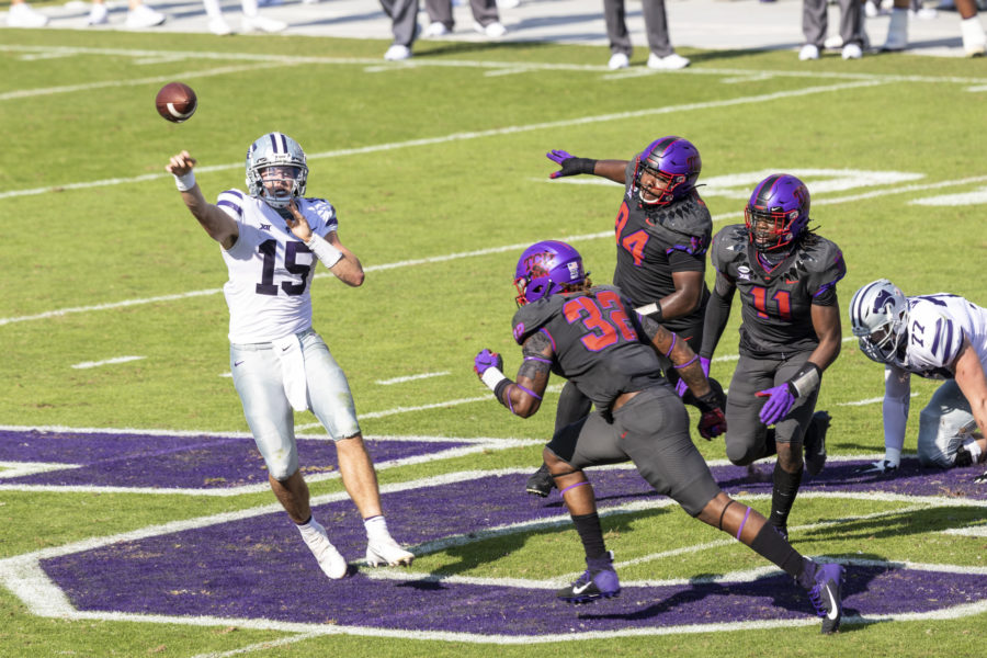 TCU defenders put pressure on Kansas State Quarterback Will Howard.