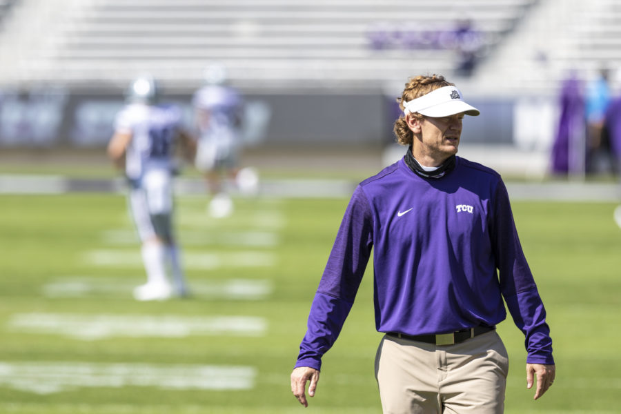 Offensive Coordinator Sonny Cumbie walks across the field during pregame warm-ups.