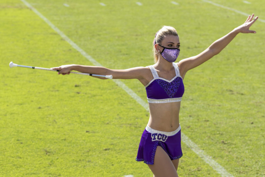 A majorette performs baton twirls during the Kansas State football game.