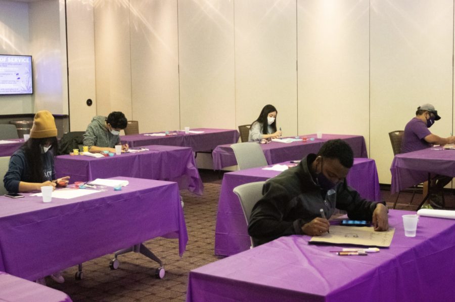 Students paint canvases during TCU's Day of Service.