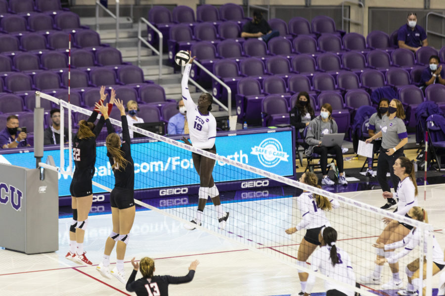Afedo Manyang spikes the ball in a volleyball game against Texas Tech.