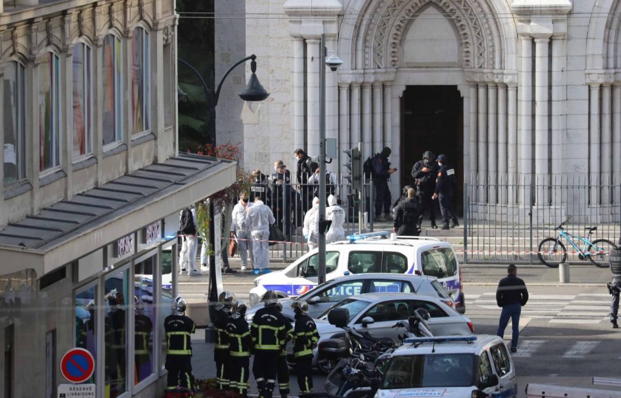 French members of the elite tactical police unit RAID enter to search the Basilica of Notre-Dame de Nice as forensics officers wait outside after a knife attack in Nice on October 29, 2020. - A man wielding a knife outside a church in the southern French city of Nice slit the throat of one person, leaving another dead and injured several others in an attack on Thursday morning, officials said. The suspected assailant was detained shortly afterwards, a police source said, while interior minister Gerald Darmanin said on Twitter that he had called a crisis meeting after the attack. (Photo by Valery HACHE / AFP) (Photo by VALERY HACHE/AFP via Getty Images)