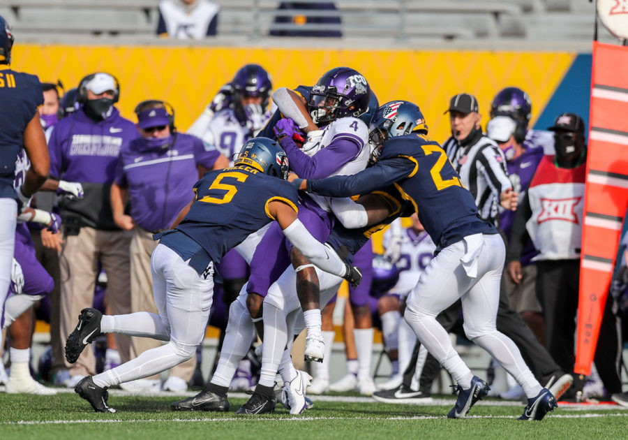 TCU Horned Frogs wide receiver Taye Barber is tackled by many West Virginia Mountaineers players during the second quarter at Mountaineer Field at Milan Puskar Stadium.