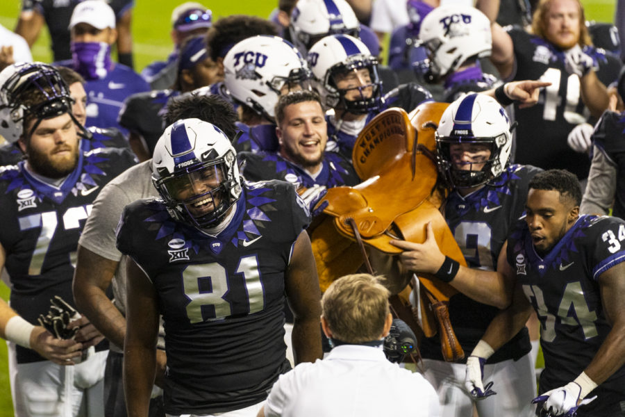 TCU celebrates with the Saddle Trophy, which goes to the winner of the teams matchup with Texas Tech every year. TCU played Texas Tech on Saturday, Nov. 7, 2020. (Heesoo Yang/Staff Photographer)
