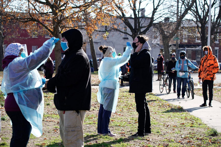 In this Dec. 10, 2020, file photo, registered nurses swab patients during testing for COVID-19 organized by Philadelphia FIGHT Community Health Centers at Mifflin Square Park, in south Philadelphia. (AP Photo/Matt Slocum, File)