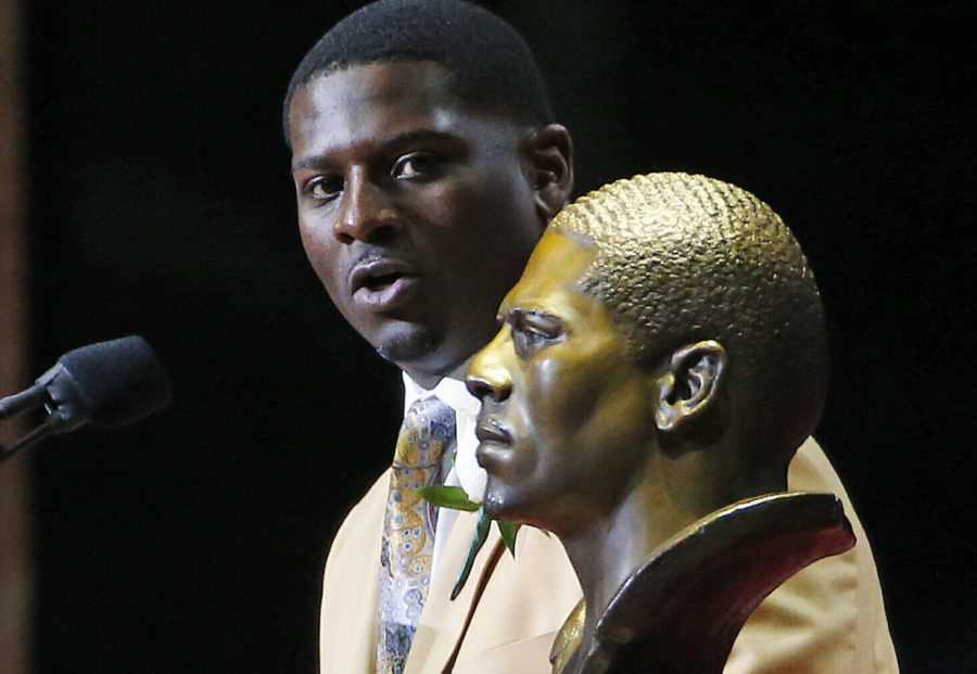 LaDainian Tomlinson speaks next to a bust of him at the Pro Football Hall of Fame inductions Saturday, Aug. 5, 2017, in Canton, Ohio. (AP Photo/Ron Schwane)