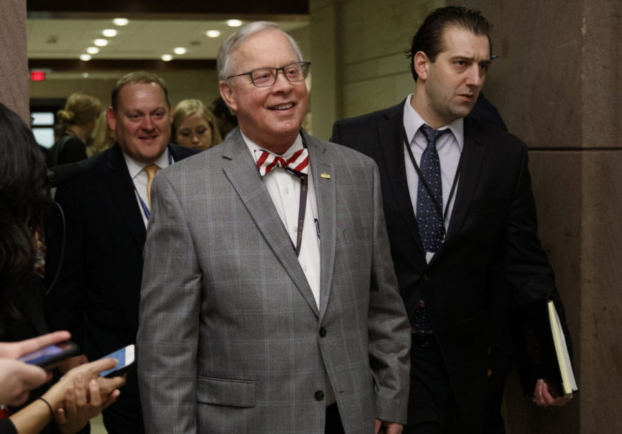In this Nov. 15, 2018 file photo, U.S. Rep. Ron Wright, R-Texas, walks to a session during member-elect briefings and orientation on Capitol Hill in Washington. Wright, the Texas Republican who had battled health challenges over the past year including lung cancer treatment died Sunday, Feb. 7, 2021, more than two weeks after contracting COVID-19, his office said Monday, Feb. 8.  He was 67. (Carolyn Kaster/AP Photo)
