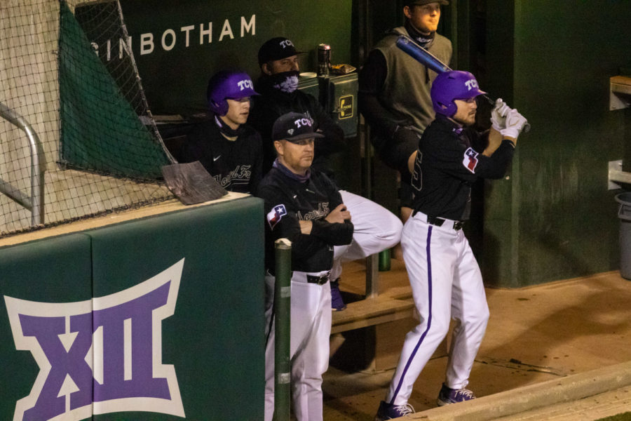 TCU Head Baseball coach watches the game from the dugout