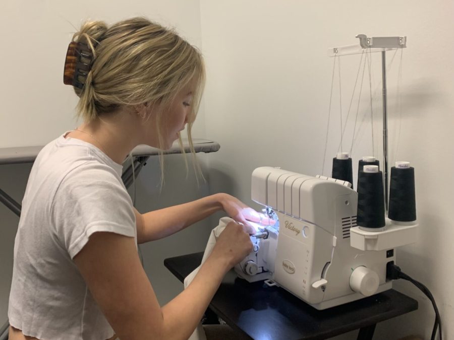 Olivia Satkiewicz sews on the finishing touches to one of her designs. Satkiewiczs brand, Designed by Liv, has been featured on Turbulent & Company since August. (Katherine Lester/TCU360 Staff)