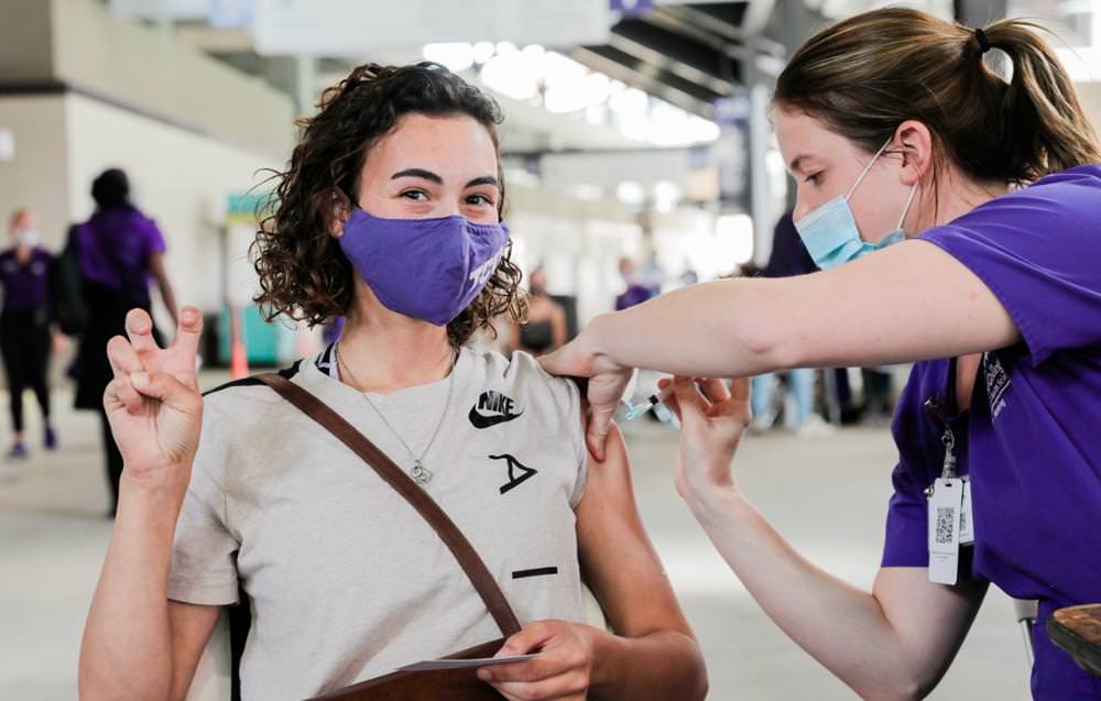 Senior nursing major Bailey Cook (right) administers a COVID-19 vaccine at the university's walk-up clinic.