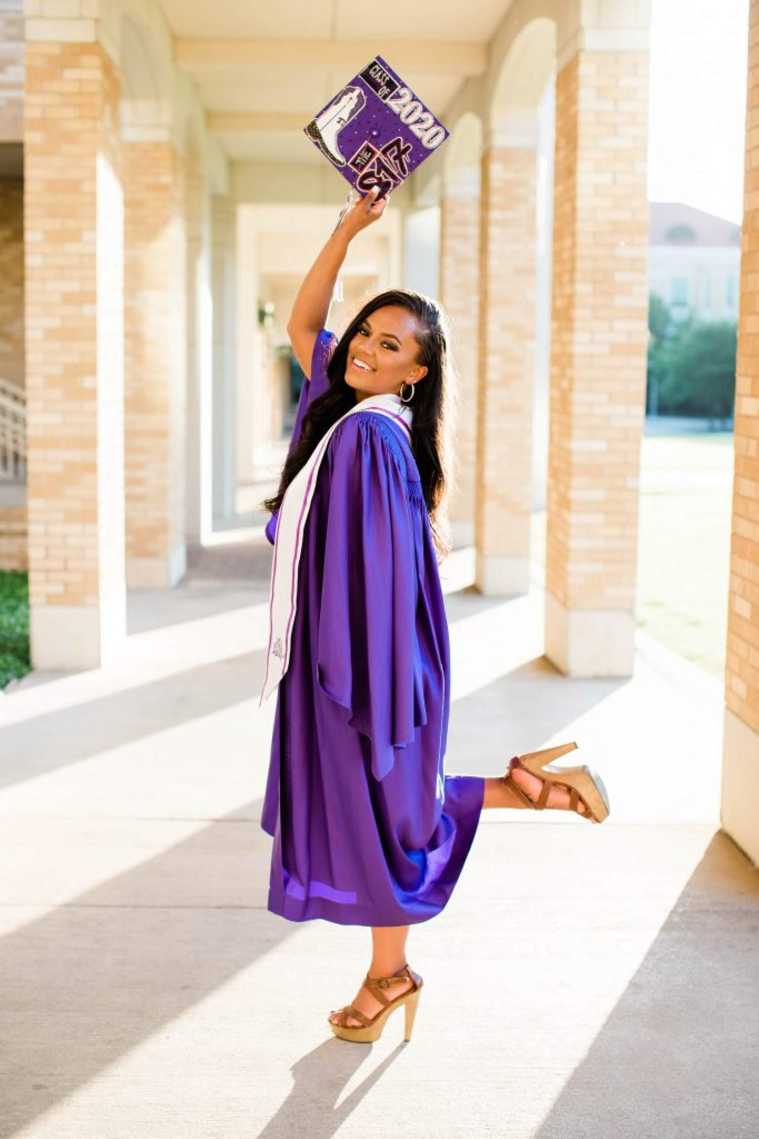 Olivia Moody posed for a picture in her graduation gown in the TCU Commons.