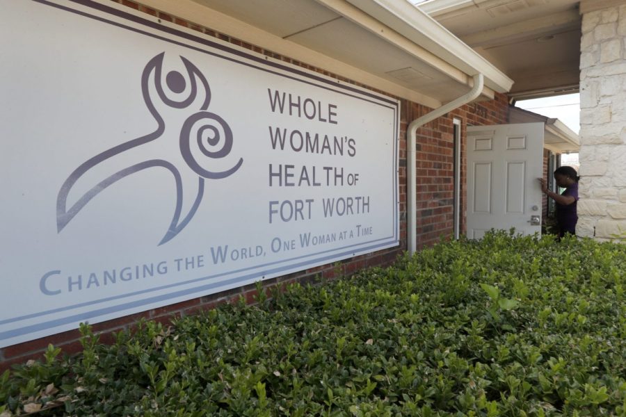 Clinic manager Angelle Harris walks in the front door of the Whole Womans Health clinic in Fort Worth, Texas, Wednesday, Sept. 4, 2019. Faced with drives of four hours or more to Fort Worth, Dallas, El Paso or out-of-state clinics, many women in West Texas and the Panhandle need at least two days to obtain an abortion _ a situation that advocates say exacerbates the challenges of arranging child care, taking time off work and finding lodging. Some end up sleeping in their cars. (AP Photo/Tony Gutierrez)