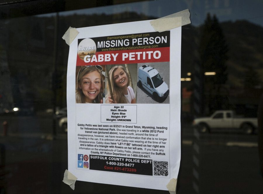 This Thursday, Sept. 16, 2021, photo, shows a Suffolk County Police Department missing person poster for Gabby Petito posted in Jakson, Wyo. Petito, 22, vanished while on a cross-country trip in a converted camper van with her boyfriend. Authorities say a body discovered Sunday, Sept. 19 in Wyoming, is believed to be Petito. (AP Photo/Amber Baesler)