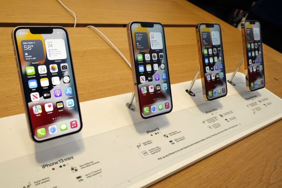 The line-up of the Apple iPhone 13 is displayed on their first day of sale, in New York, Friday, Sept. 24, 2021. They are, from left: iPhone 13 mini, iPhone 13, iPhone 13 Pro, and iPhone 13 Pro Max. (AP Photo/Richard Drew)