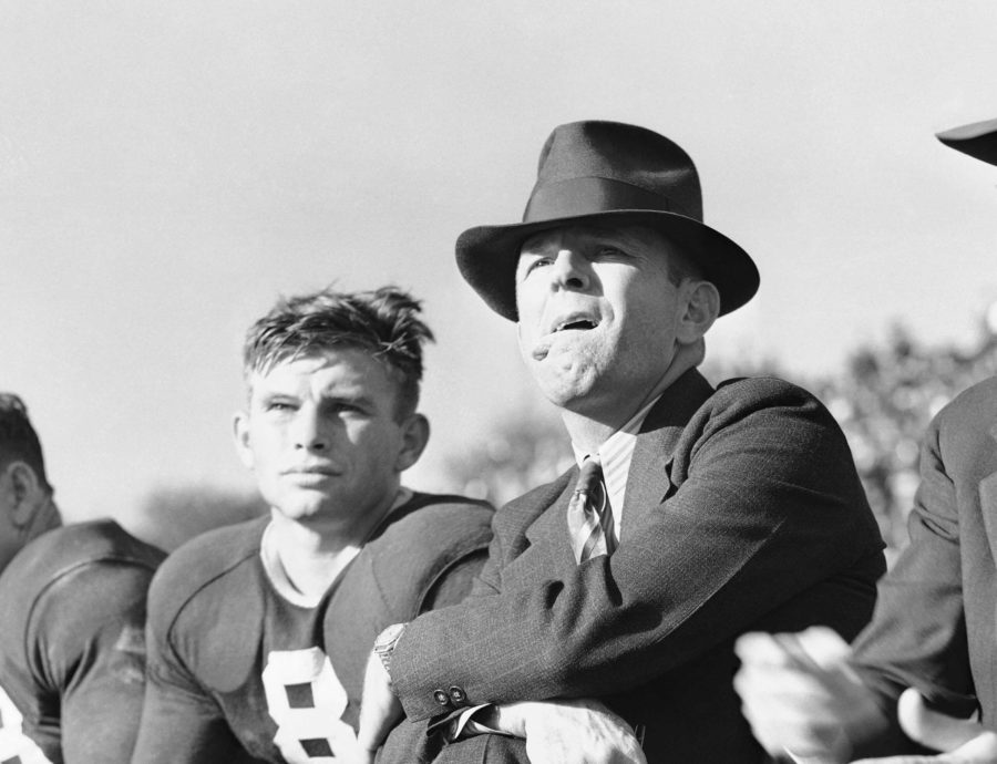 Coach Dutch Meyer of Texas Christian University, right, continued an old custom of sticking his tongue out at the TCU-Rice Game in Fort Worth, Texas, Nov. 19, 1939. The worried look and alfresco tongue go together whenever Meyers ace passer and field general, Davey OBrien, is out of a game. That happens to be OBrien alongside the coach. TCU won. (AP Photo)